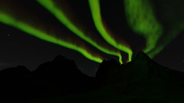 A beautiful animation of the northern lights, with green lights dancing across the sky, makes for a fantastic background