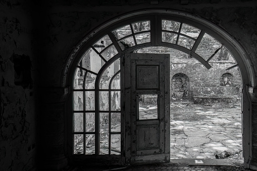 An old wooden arch doorway in an abandoned building in Greece