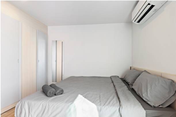 istock White bedroom in minimalist style with a comfortable gray bed. 1621003980
