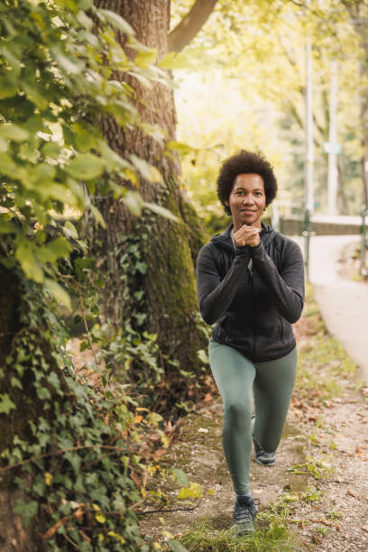 istock Black Woman Doing Lunges Exercise Before Jogging In Nature 1621020257