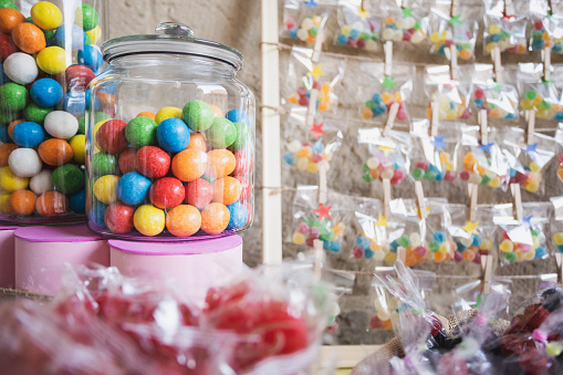 Tasty colorful candies on wooden table, space for text