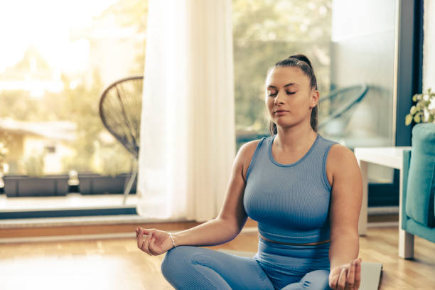 istock Woman Practicing A Yoga Routine At Home 1621028266