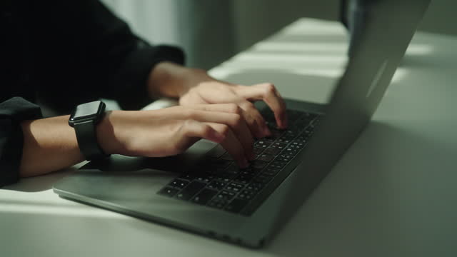 Typing on keyboard laptop.