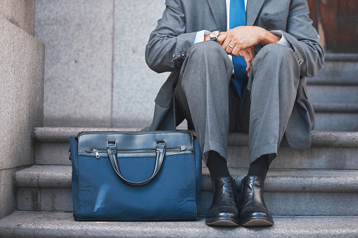 Lawyer, briefcase and man shoes on city and urban steps of government building outdoor. Businessman, justice and luggage for professional work of employee on a break of legal career of a attorney