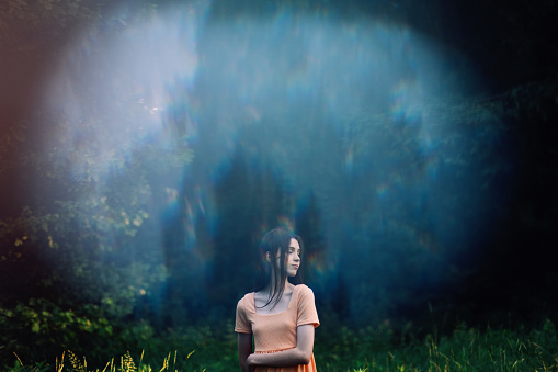 Holistic and Integrative Medicine. Mind-Body Therapies, relaxation techniques. Outdoor portrait of Young woman in nature background with reflection.
