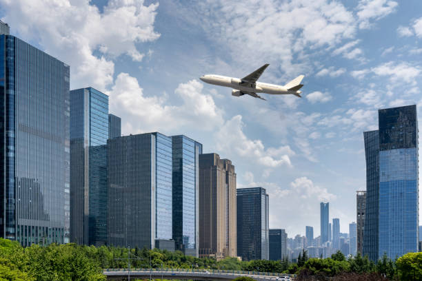 istock plane fly over modern cityscape with office buildings and skyline. 1621076196