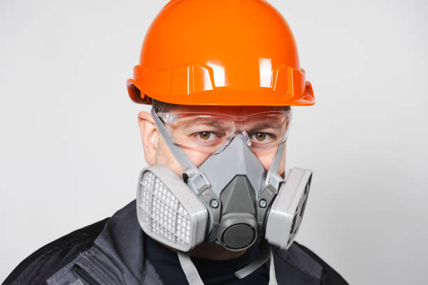 istock A man wearing a helmet, respirator and goggles on a white background 1621080126