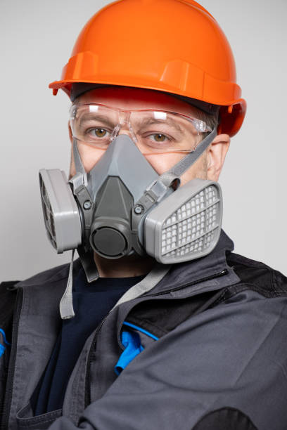istock A man wearing a helmet, respirator and goggles on a white background 1621080441