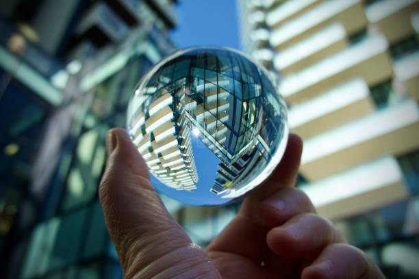 istock hand holding crystal ball with skyscrapers background 1621106200