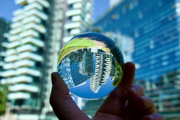 istock hand holding crystal ball with skyscrapers background 1621106204