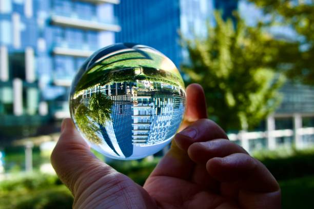 istock hand holding crystal ball with skyscrapers background 1621106730