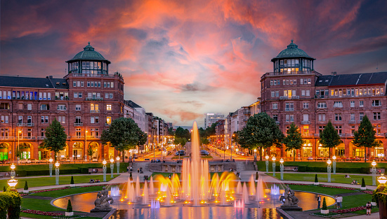 Mannheim, Germany. View on Friedrichsplatz at sunset with fountain creating splendid water and color effects. 2013-06-16.