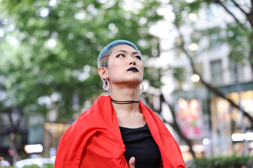 Generation Z and LGBTQ Transgender Female : Asian female transgendered person in outdoors.
Harajuku Tokyo Japan.
Gen-Z Her hair is shaved and add color the rainbow.