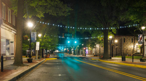 istock Nighttime tranquility on Main Street. Empty illuminated road with traffic lights in Downtown Dover, DE. 1621130711