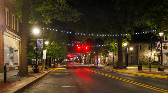 Main Street in Downtown Dover, Delaware - W Loockerman St at night with traffic lights and cars.