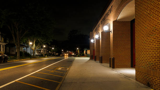 istock Fire Department building on empty street at night. Illuminated brick public building with arcs and entrance along the road. W Reed St, Downtown Dover, DE. 1621130725