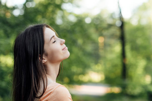 istock Ways To Unplug From Technology and Be Present. Unplugging from Technology and Living a More Mindful Life. Outdoor portrait of young woman enjoying nature 1621167098