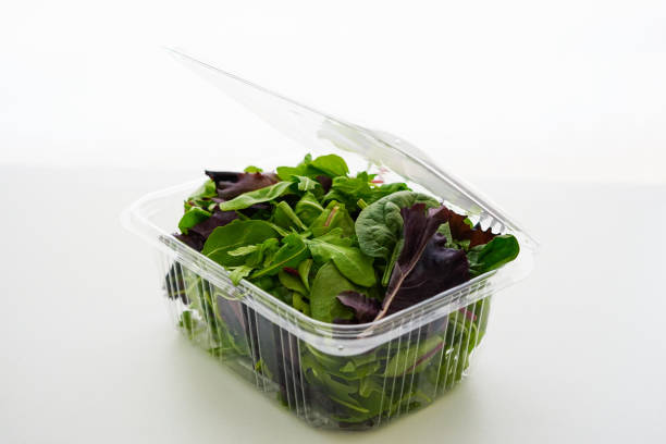 istock Fresh Green salad in recyclable plastic container on white background 1621172019