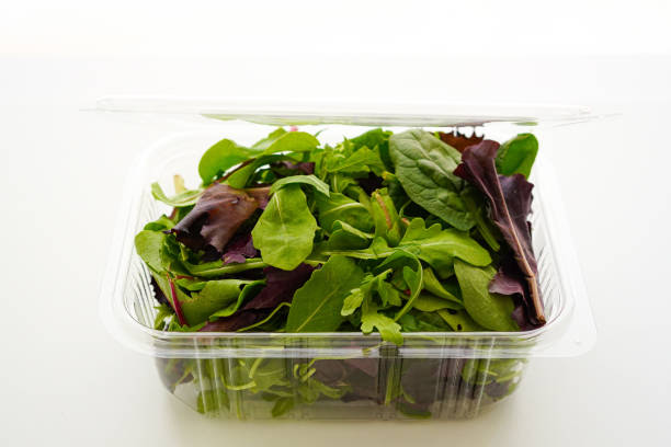istock Fresh Green salad in recyclable plastic container on white background 1621172062