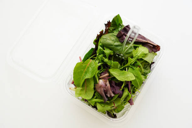istock Fresh Green salad in recyclable plastic container on white background 1621174213