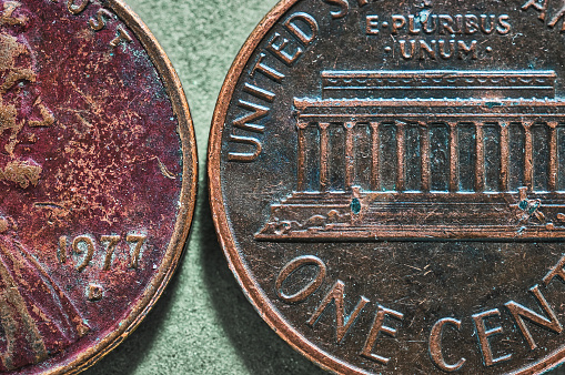 macro close-up of two heavily oxidized pennies