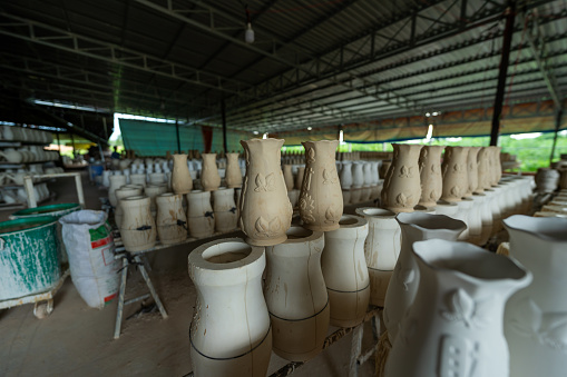 Traditional craft village making pottery and porcelain cups containing rubber tree latex in Tay Ninh, Vietnam. Business and travel concept