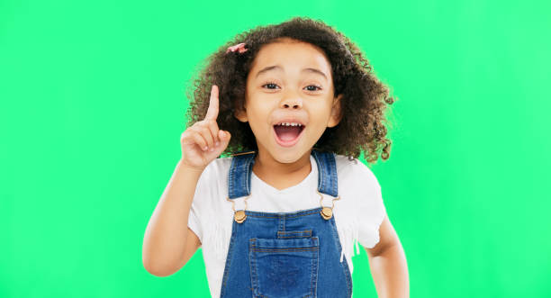 istock Idea, thinking and child pointing up at mockup space or green screen isolated against a studio background. Portrait, cute and smart, clever and intelligent kid or young person for brand placement 1621208656