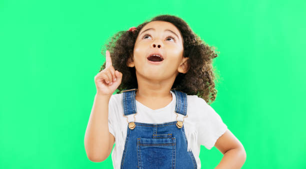 istock Idea, thinking and child pointing up at mockup space or green screen isolated against a studio background. Portrait, cute and smart, clever and intelligent kid or young person for brand placement 1621208661