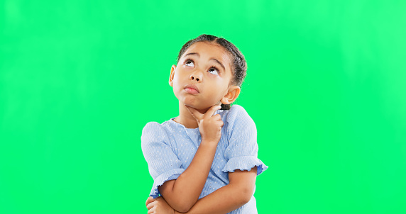 Green screen, thinking and confused child in studio with decision, contemplation and pensive on mockup background. Doubt, emoji and unsure girl contemplating choice, why or solution while isolated