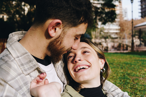 Loving couple embracing in public park