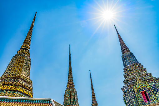 Ceramic Chedis Spires Pagodas Stretching to Sun Wat Pho Po Temple Complex Bangkok Thailand. Built in 1600s. One of oldest temples in Thailand.