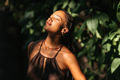 Portrait of a multi-racial woman enjoying in a forest. Natural beauty