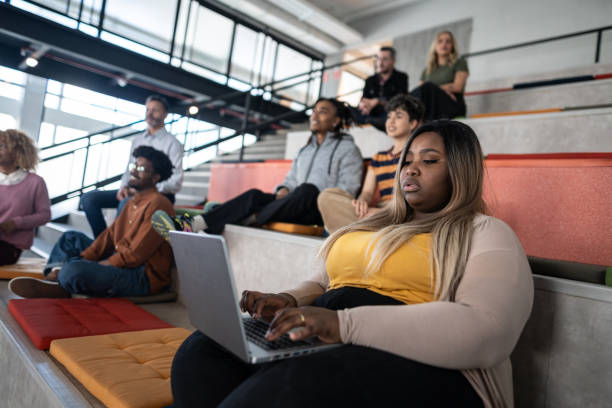 istock Young woman using laptop at auditorium 1621254362