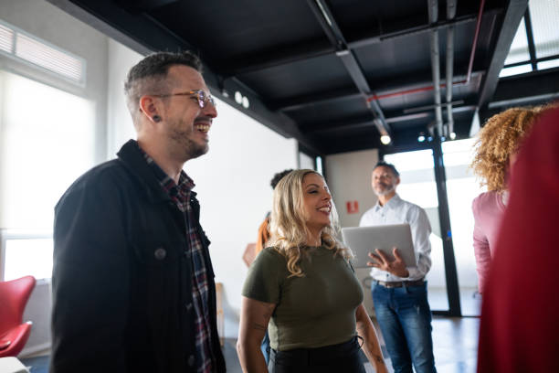 istock Happy coworkers talking at office 1621255499