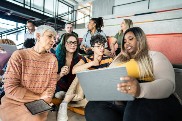 Businesswomen talking and using laptop during a meeting at auditorium