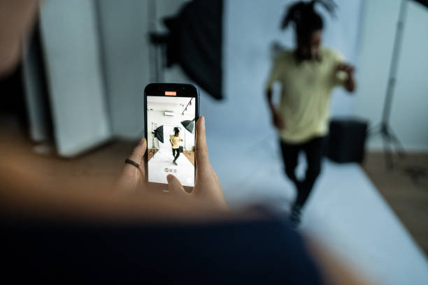 istock Photographer taking photos/filming a model dancing at studio 1621264501