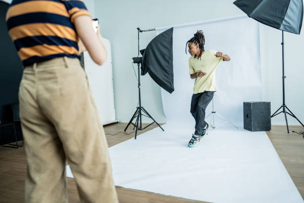 istock Photographer taking photos/filming a model dancing at studio 1621264502