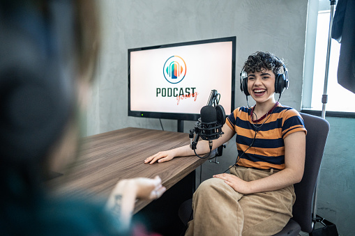 Young woman talking during a interview at podcast