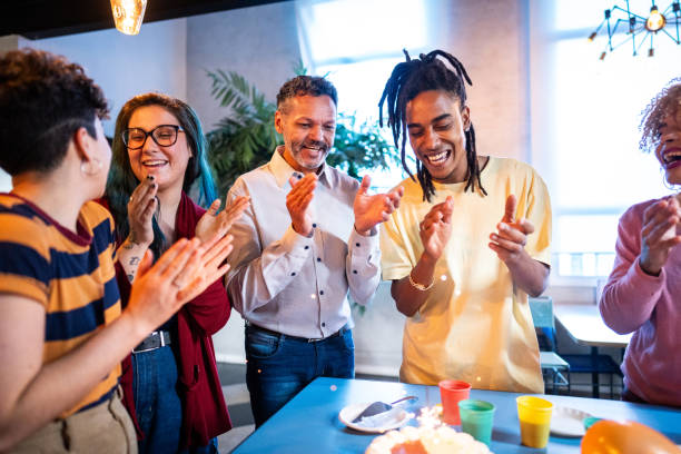 istock Coworkers clapping during a birthday office party 1621289793