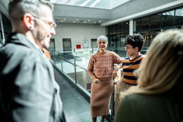 istock Coworkers talking at office lobby 1621302212