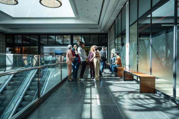 istock Coworkers talking at shopping mall 1621304324