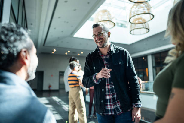 istock Coworkers talking at office lobby 1621304891