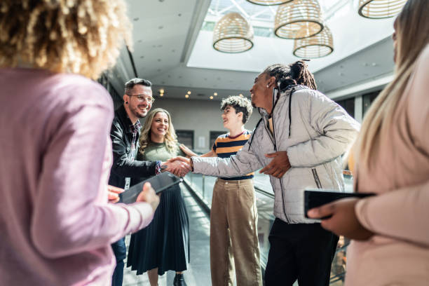 istock Coworkers greeting at office lobby 1621310646