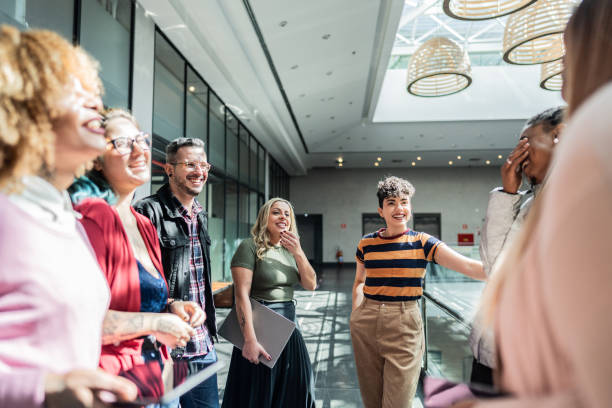 istock Coworkers talking at office lobby 1621311010
