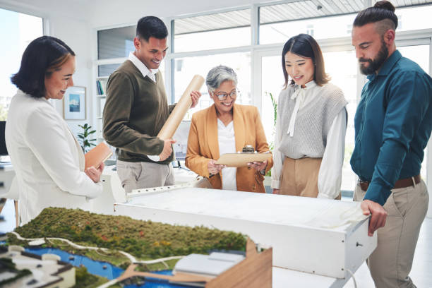 istock Business, group and staff with blueprint, architecture or planning with teamwork, brainstorming or meeting for development. People, engineer or coworkers with paperwork, conversation or collaboration 1621318375
