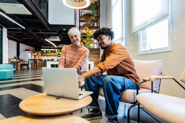 CEO/Director woman talking with employee while use laptop at office