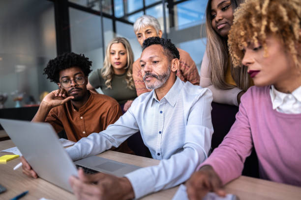istock CEO/Director man talking with employees while use laptop at office 1621321080