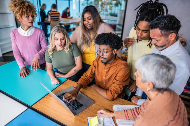 istock Business person/coworkers talking while use laptop at office 1621335188