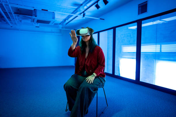 istock Young woman using a VR glasses at office/studio 1621337540