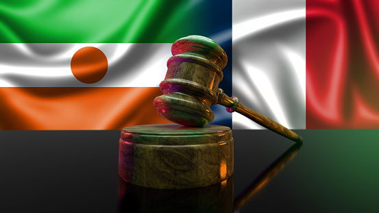 Niger's Flag and Crisis: Understanding the Current Situation. Niger's law and justice concept. Wooden gavel with flag of Niger.